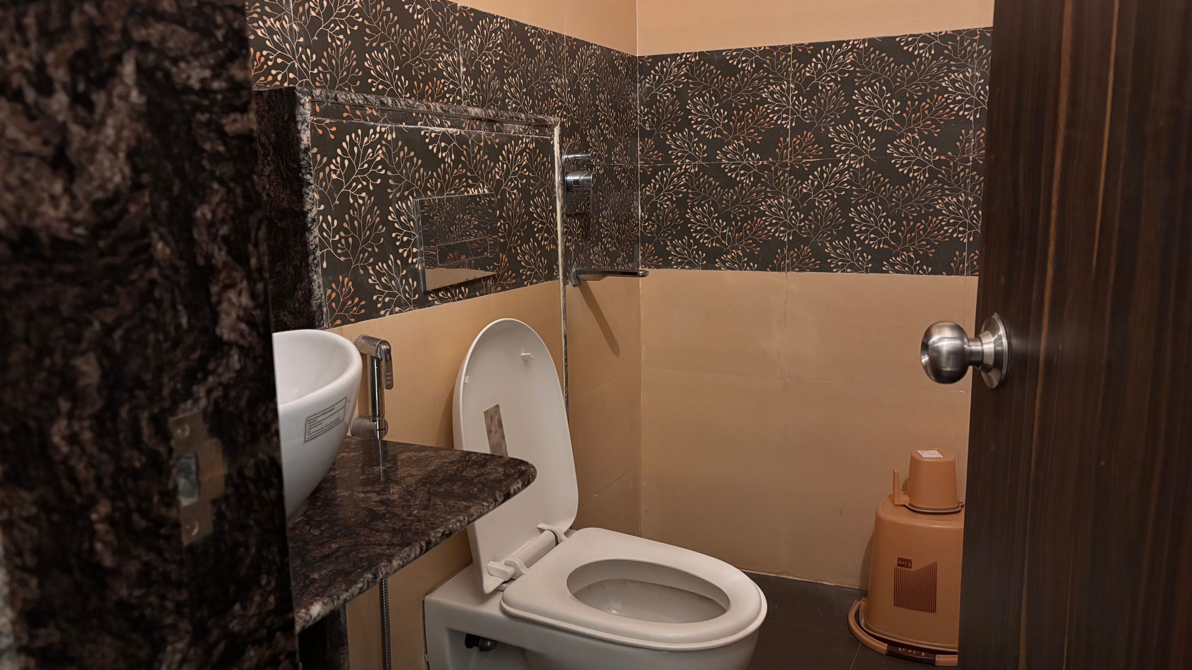 A bathroom with a toilet, sink, and shower.