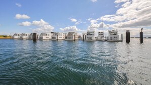 A waterfront property with multiple floating structures connected by walkways. - Beach front ship in Olpenitz with sauna (Olpenitz)
