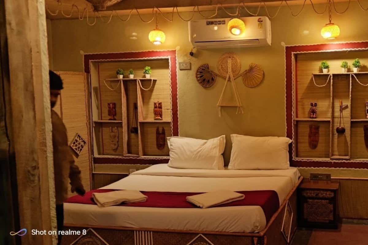 A traditional room with a bed, shelves with decorative items, and a wall-mounted air conditioner.