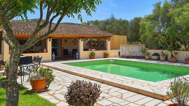 A house with a tiled roof, a swimming pool, and potted plants. - Finca in Mallorca with Private Pool & Views (Son Macià)