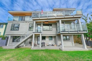 A modern two-story house with a balcony, a staircase, and a small outdoor seating area. - 3 BR Seaside Bliss-Close to the beach-OCEAN VIEW! (White Rock)