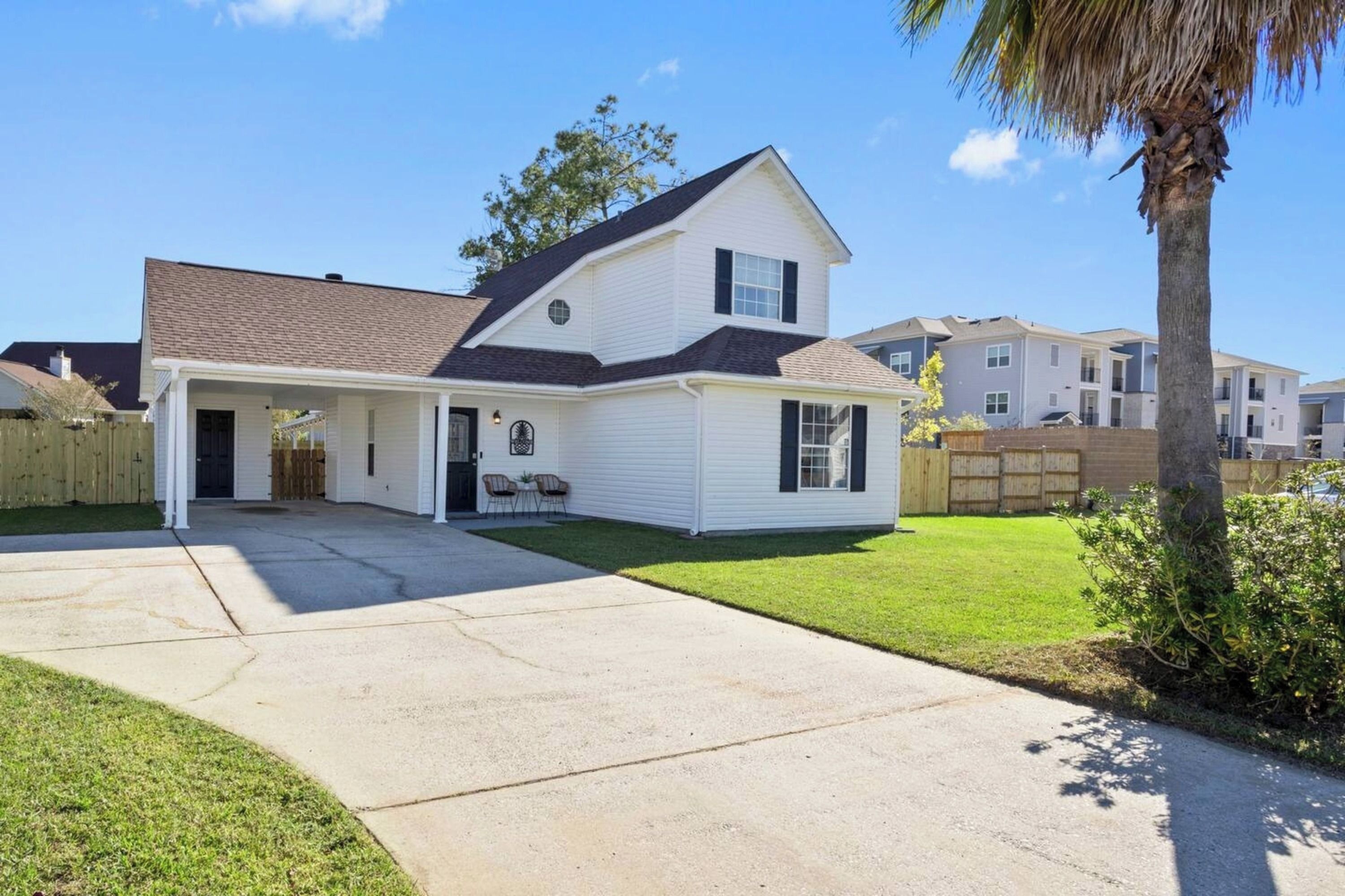 A single-story house with a front porch, a covered entryway, and a well-maintained lawn.