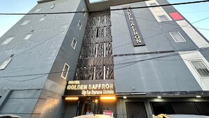 A hotel named "Golden Saffron" with a modern architectural design, featuring a prominent facade and signage. - Qotel Comfort Golden Saffron Punjabi Bagh (New Delhi)