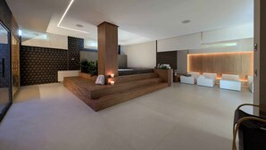 A modern spa area with a wooden reception desk, seating area, and a large wooden column. - Alternative Relax Rooms by Oikia Vacanze (Scorrano)