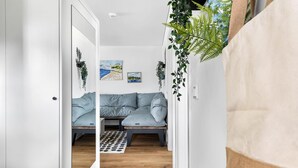 A hallway leading to a living room with a sofa, two paintings, and a patterned rug. - Pet friendly apartment in Olpenitz (Olpenitz)