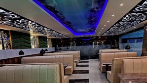 A modern interior with seating and a patterned ceiling. - Hotel Holiday Saharsa (Saharsa)