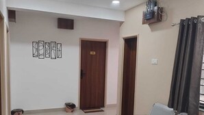 A waiting area with a ceiling fan, a reception desk, and a door marked with the number 308.