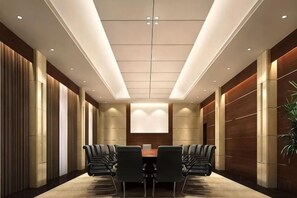 A conference room with a long table, chairs, and a projector screen. - Royal Hotel (Chongqing Liangjiang) (Chongqing)