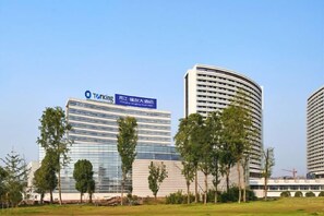 A modern building with a sign that reads 'Torking' and 'PITCHEY, HARRIS & ROMANS.' - Royal Hotel (Chongqing Liangjiang) (Chongqing)