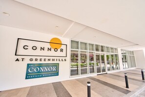 A building entrance with a sign reading "CONNOR AT GREENHILLS" and "THE CONNOR SERVICED RESIDENCES". - The Connor Serviced Residences Managed by HII (San Juan)