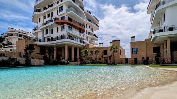 A modern apartment building with a swimming pool in front. - ASTER sea & spa dúplex (Villajoyosa)