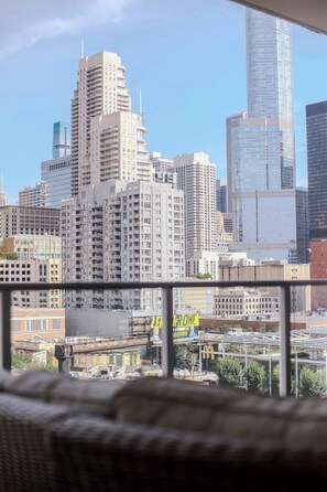 A city skyline with high-rise buildings, including a distinctive curved skyscraper.