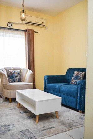 Deluxe Apartment | Living area | 24-inch Smart TV with digital channels - Lux Suites Buxton Point Apartments (Mombasa)