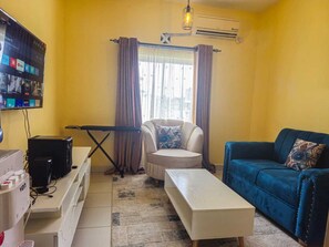 Deluxe Apartment | Living area | 24-inch Smart TV with digital channels - Lux Suites Buxton Point Apartments (Mombasa)