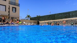 A swimming pool with lounge chairs and a lifebuoy. - Aqua Vista 2 bed Penthouse With Great Views (Adeje)