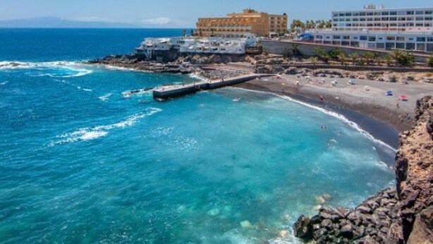 A coastal hotel with a beach view, a rocky shoreline, and a clear blue sea. - Aqua Vista 2 bed Penthouse With Great Views (Adeje)