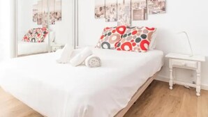 A bedroom with a bed, a bedside table, a chair, and a large window. - Central 2bedroom 200m From Beach (Adeje)