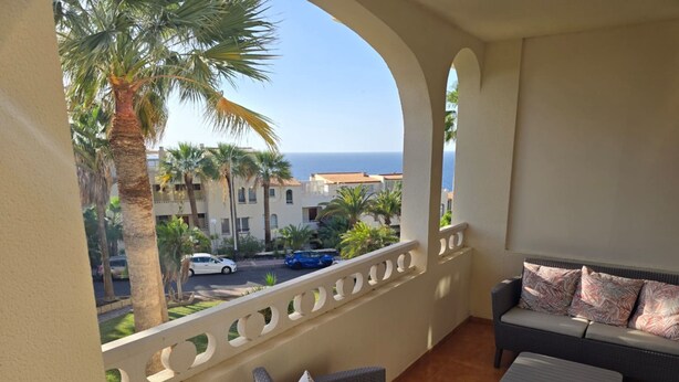 A balcony with wicker furniture and a view of the ocean. - Sun Kissed Vacation Home 3BR Retreat by the Ocean (Adeje)