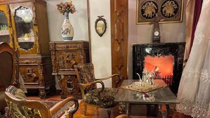 A traditional room with ornate furniture, a fireplace, and decorative wall art. - Dokki apartment  (Giza)
