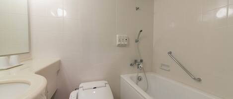A bathroom with a toilet, sink, and bathtub.