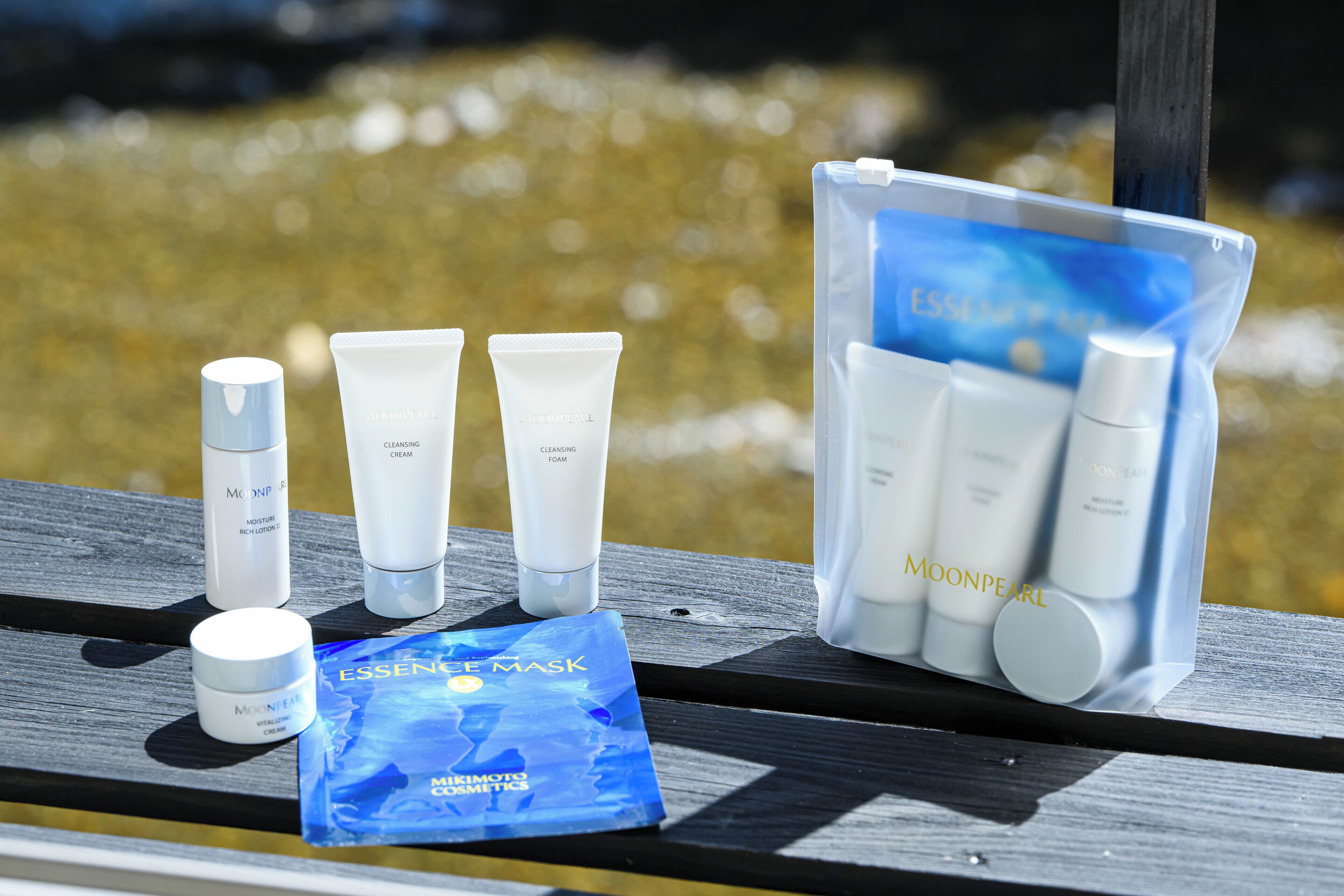 A selection of MoonPearl skincare products arranged on a wooden surface.