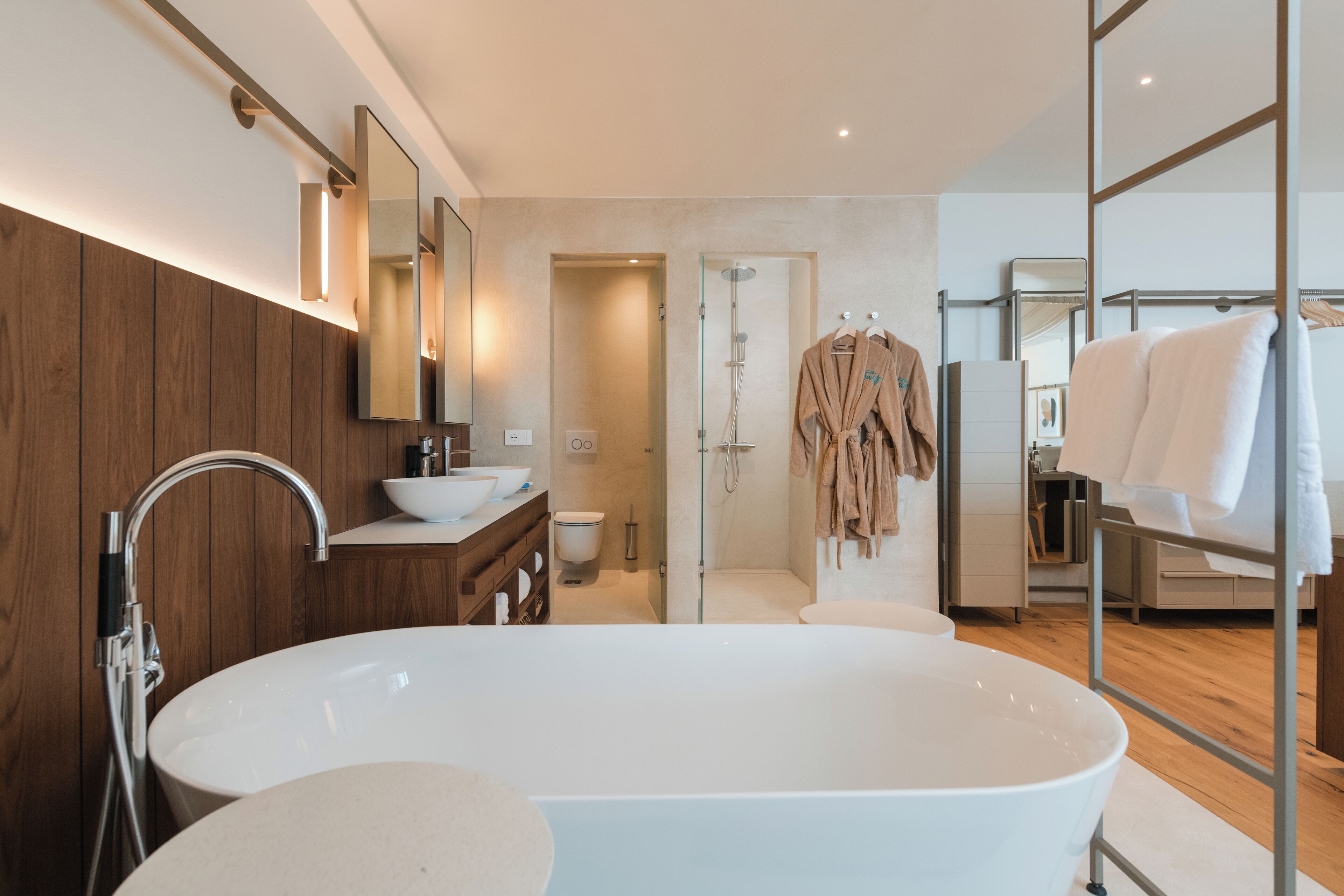 Un bagno moderno con una vasca freestanding, un mobile lavabo con lavandino e una cabina doccia.