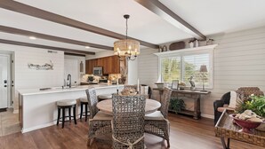 A spacious kitchen with a central island, wooden flooring, and a chandelier. - Ocean Front Paradise, Fantastic Views! sleeps 4 (St Simons Island)