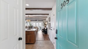 A hallway with a kitchen area, a dining table, and a door labeled '305'. - Ocean Front Paradise, Fantastic Views! sleeps 4 (St Simons Island)