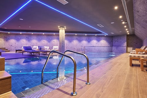 Indoor pool, open 10:00 AM to 10:00 PM, pool loungers