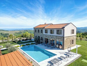 A two-story house with a swimming pool, outdoor seating, and a view of the countryside. - 5 Star Luxurious Villa Paradiso d'Istria with Spa and pool (Kucibreg)