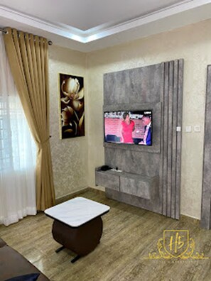 Luxury Suite, Non Smoking | Living area | 32-inch Smart TV with cable channels