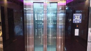 An elevator with a 'Ground Floor' sign above, a 'MAX 3 PEOPLE' notice, and a digital display showing the number 5. - Sami Resort  (Tirupattur)