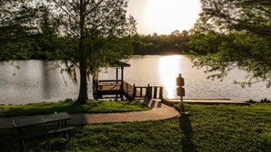 A lakeside park with a gazebo, picnic table, and a walking path. - Apartment Minutes From Disney (Kissimmee)