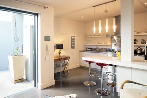 Apartment, 1 Queen Bed, Patio | Private kitchen | Microwave, oven, stovetop, dishwasher - De Waterkant Guest Suites (Cape Town)