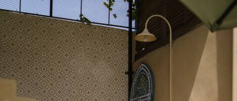 A staircase with patterned tiles, a potted plant, and a decorative door.