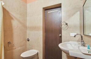 Bathroom features a toilet, sink, and mirror.