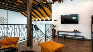 A modern interior with a wooden ceiling, a TV mounted on the wall, a bench, and a staircase with a metal railing. - Luxury Villa Meden Dol with heated pool, Hot-Tub, 2 Saunas (Skradin)