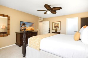 A bedroom with a bed, a ceiling fan, a television, a dresser, and a door. - Wailea Elua Village | Ocean View 2 BR | Car Incl. w/ 6+ Nights | WEV-2009 by KBM (Wailea)