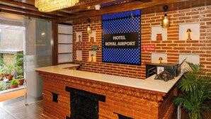 A reception desk with a sign reading "HOTEL ROYAL AIRPORT" and a "Check Out Time" sign. - Hotel Royal Airport (Kathmandu)