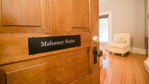 A wooden door with a sign reading "Mahaney Suite." - Mahaney Suite BW Boutique Hotel (Central Lake)