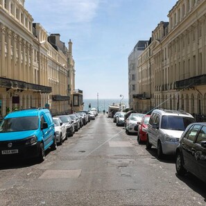 A street lined with parked cars and buildings on both sides. - Short Walk to I360 and Beach 5 Condo With Patio (Brighton)