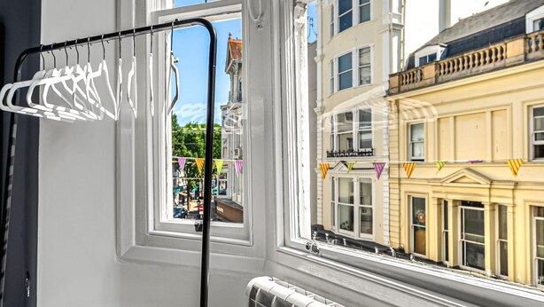 A room with a window, a radiator, and a drying rack. - The Lanes Getaway Moments Away From Pier Beach (Brighton)