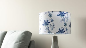 A lamp with a floral-patterned lampshade on a bedside table next to a couch. - Gorgeous 5 Star Location 2 min to Brighton Beach (Brighton)