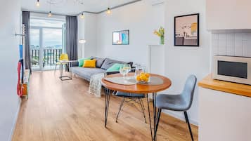 Apartment, Balcony, City View | Living area | 45-inch LED TV with digital channels