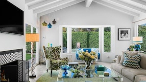 A modern living room with a glass coffee table, patterned sofas, and a fireplace. - The Colony Hideaway - Pool Wifi Spa Private (Palm Springs)
