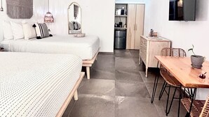 A modern bedroom with a bed, bedside table, and a ceiling fan. - Studio Yuca - at Loreto 80 downtown  (Loreto)