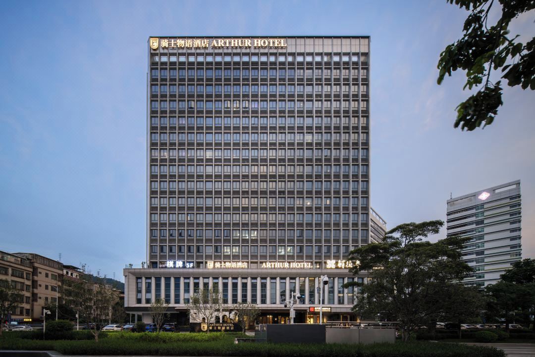 A modern Arthur Hotel building with a prominent sign, multiple floors, and a flat facade.