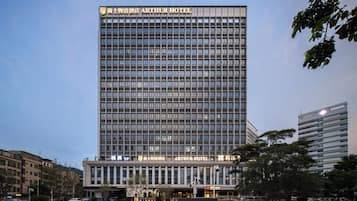 A modern Arthur Hotel building with a prominent sign, multiple floors, and a flat facade.
