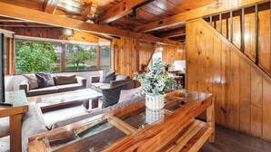 A wooden interior with a sofa, coffee table, and staircase. - Lujosa Cabaña Privada En Valle de Bravo (Valle de Bravo)
