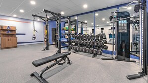 A gym with weightlifting equipment, dumbbells, and a bench. - Hampton Inn & Suites Little Rock Airport (Little Rock)